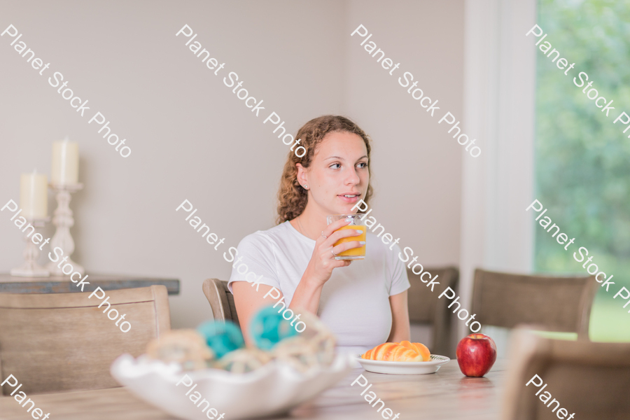 A young lady having a healthy breakfast stock photo with image ID: 9a20644d-e01b-45dc-ab90-7338ea5a2b73