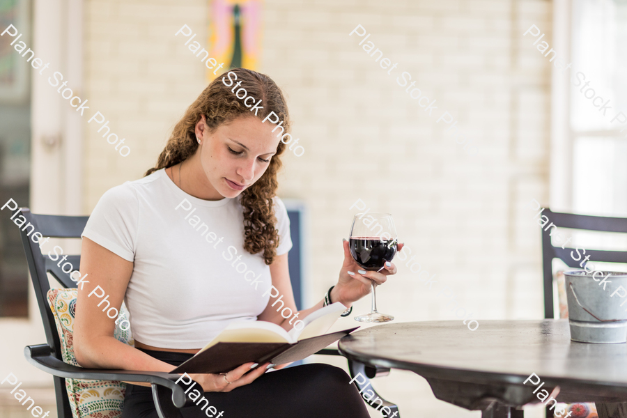 A young lady enjoying daylight at home stock photo with image ID: 9af7e141-84ee-45f9-84bd-fd17f14b1244