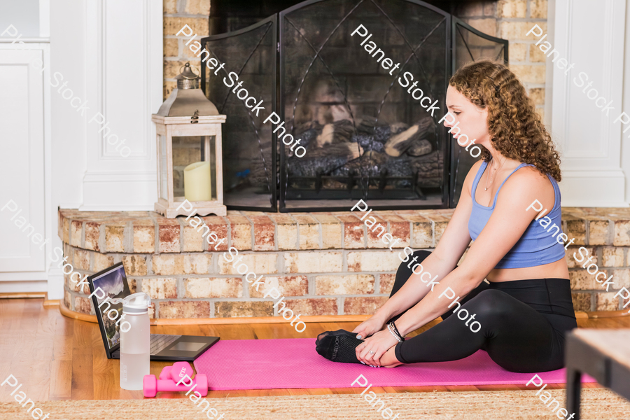 A young lady working out at home stock photo with image ID: 9b920367-1534-4edd-bf05-659e325dcec1