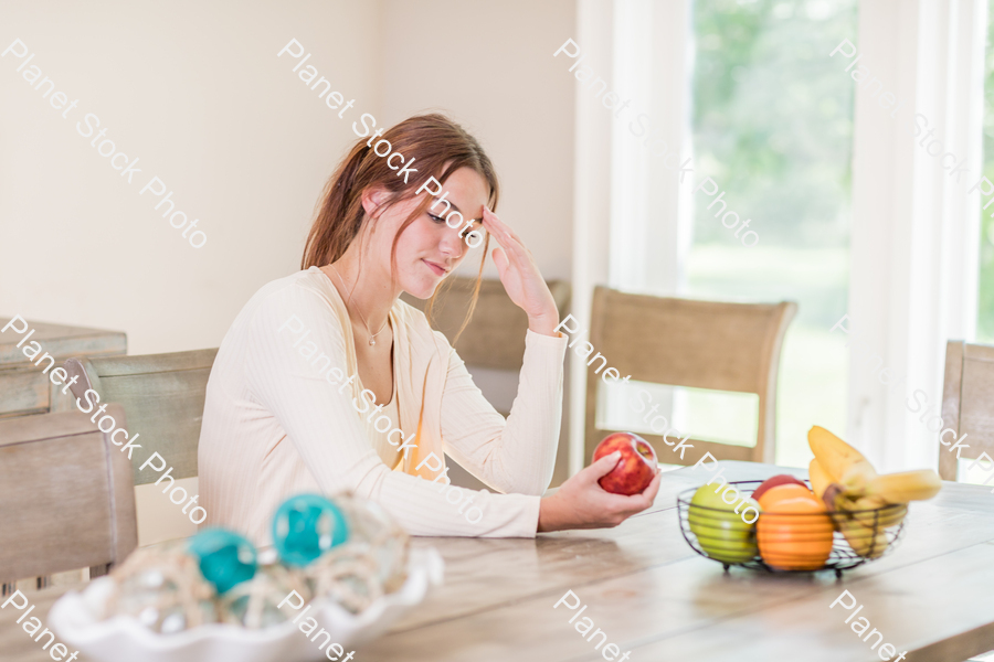 A young lady grabbing fruit stock photo with image ID: 9ecac920-3070-4439-9629-fbf7c190a3b3