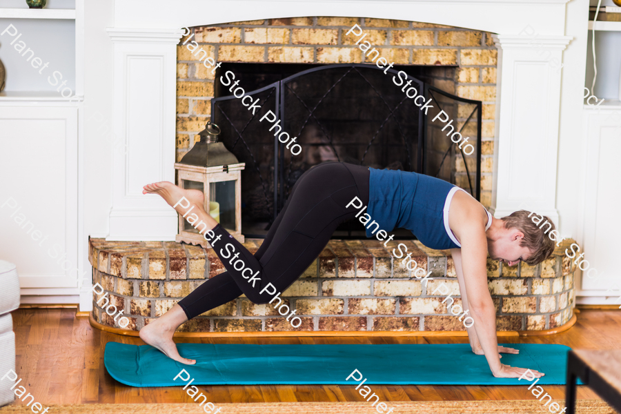 A young lady working out at home stock photo with image ID: a094122f-ef71-499b-93e7-513c88551d60