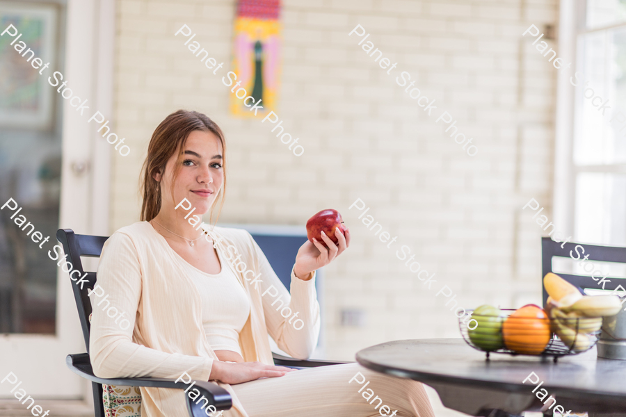 A young lady enjoying daylight at home stock photo with image ID: a0f7b056-b6c8-4e43-a16f-2044e447f172