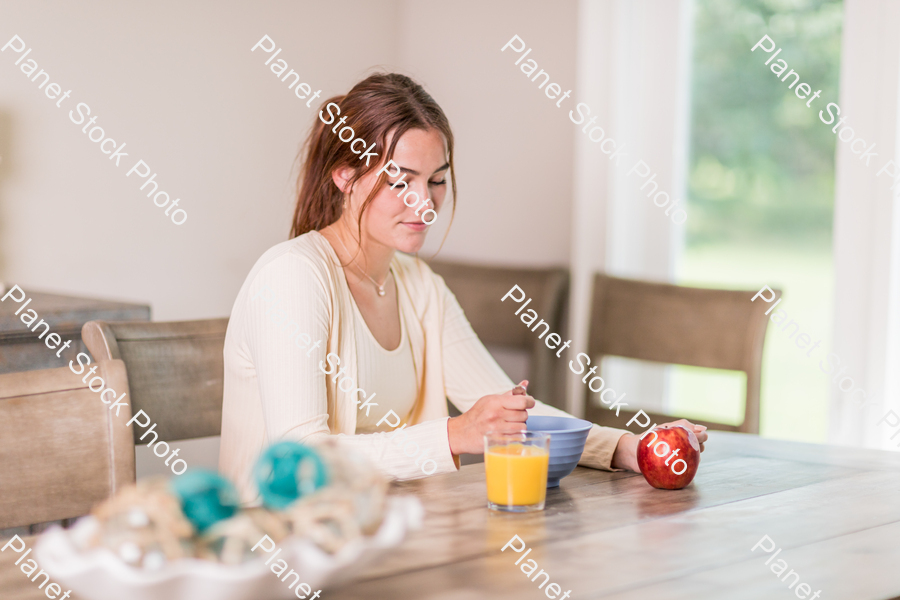 A young lady having a healthy breakfast stock photo with image ID: a160aa21-43c6-4ce4-8024-7460872efe9f
