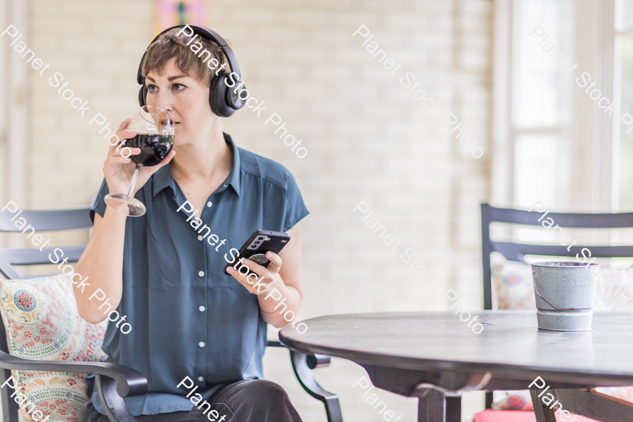 A young lady enjoying daylight at home stock photo with image ID: a2d3944b-78ab-4ae1-996d-3822dca96a48