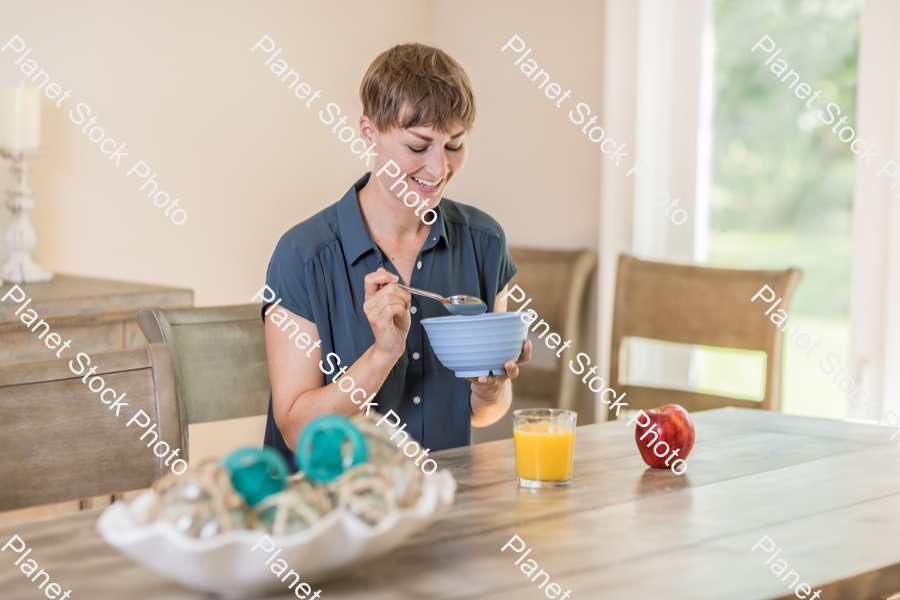 A young lady having a healthy breakfast stock photo with image ID: a8369550-ab19-4b8c-9850-026ea9c169e9