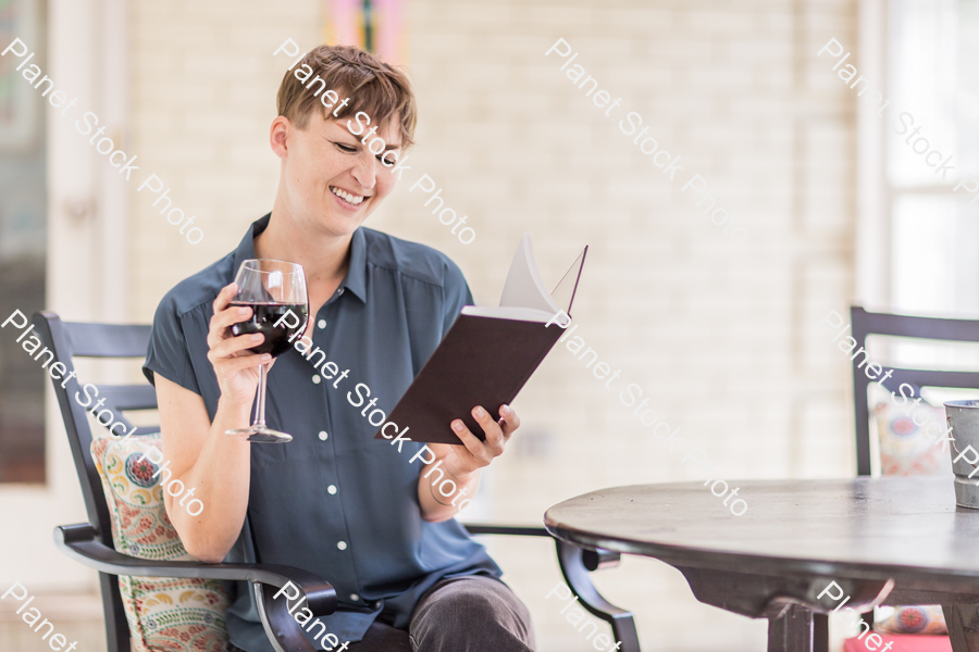 A young lady enjoying daylight at home stock photo with image ID: a8b7dabe-f49f-48c6-b3cd-ea0f86c1703f