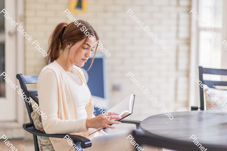 A young lady enjoying daylight at home stock photo with image ID: a9517c3f-e386-4d58-85a1-8d2f0fe1424f