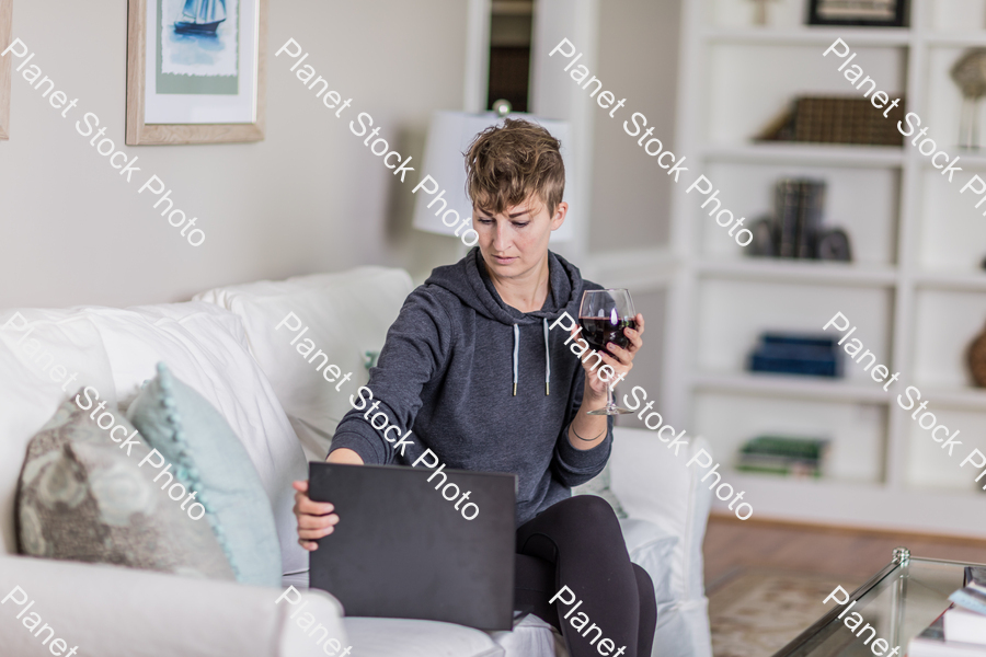 A young lady sitting on the couch stock photo with image ID: aa513b4c-34c6-4df6-a8b4-d56cf85ed32b