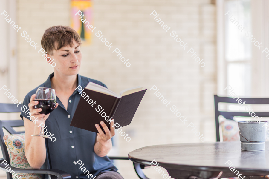 A young lady enjoying daylight at home stock photo with image ID: ad5cf3e4-f6de-426f-a534-36d775692d4b