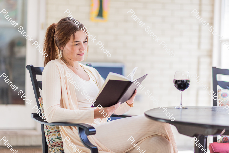 A young lady enjoying daylight at home stock photo with image ID: ae980aea-f60c-47d5-a53c-88bada2f434b