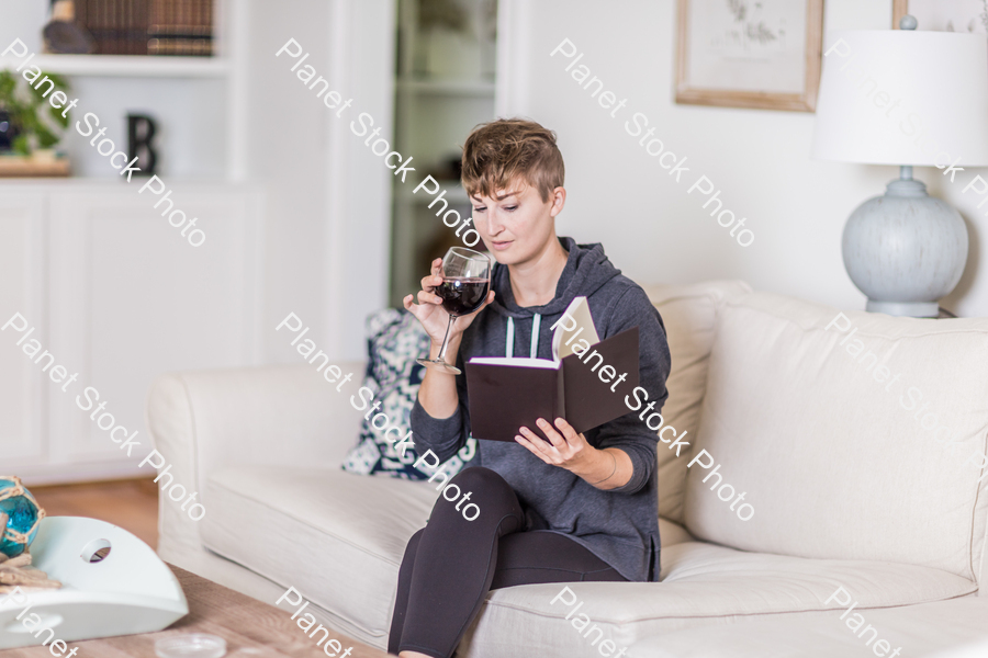 A young lady sitting on the couch stock photo with image ID: aea98985-2393-412b-a836-c2cccc7e20da