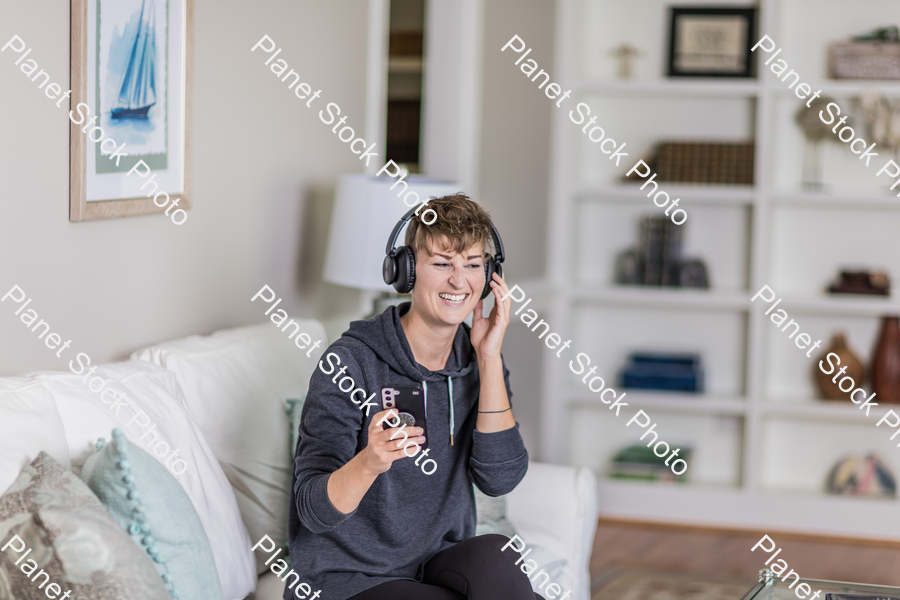 A young lady sitting on the couch stock photo with image ID: b11d2e9c-9011-4218-b931-2a995b931ec6