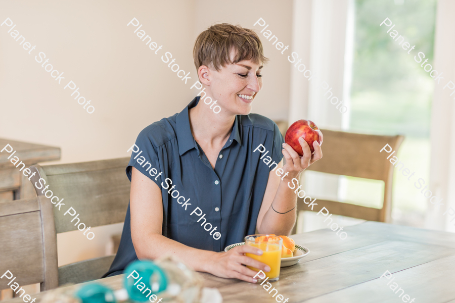 A young lady having a healthy breakfast stock photo with image ID: b15e6a24-b80e-48b0-b798-400c292ffbbd