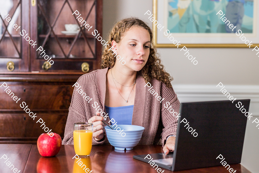 A young lady having a healthy breakfast stock photo with image ID: b38e7994-24ae-4497-9aa2-7e305e241212