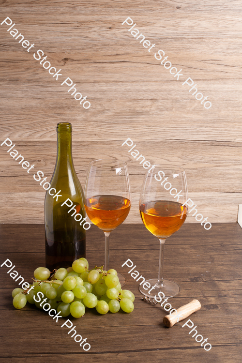 One bottle of white wine, with wine glasses, corkscrew, and grapes stock photo with image ID: b4053065-17e8-4f57-8ca8-66295319a646