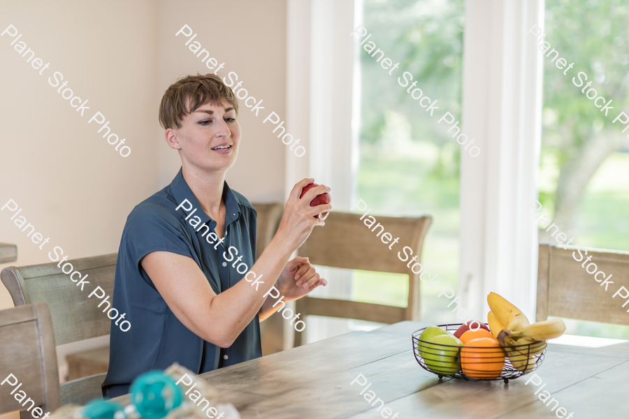 A young lady grabbing fruit stock photo with image ID: b43c479a-ee5e-4173-a120-f78e7c87a0c4