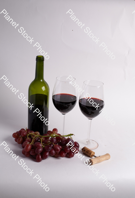 One bottle of red wine, with wine glasses, corkscrew, and grapes stock photo with image ID: b56f8aaa-e4be-4a28-9218-ffc1a1f18d76