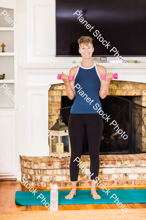 A young lady working out at home stock photo with image ID: babcf2b8-9933-4fb4-b35f-fd577d63e4a4