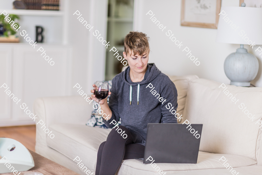 A young lady sitting on the couch stock photo with image ID: baf4b6e6-03b3-4c5c-ab83-0fe9bea4c71c