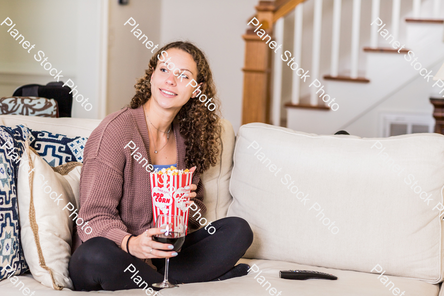 A young lady sitting on the couch stock photo with image ID: bbe83afb-0244-49ae-94fb-026ad27528f3