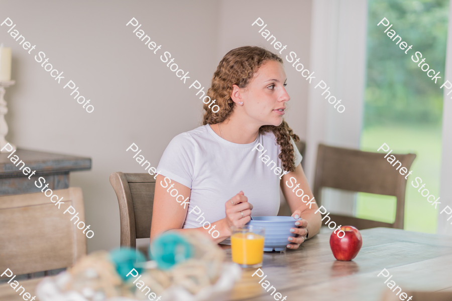 A young lady having a healthy breakfast stock photo with image ID: bd6954ac-8d35-47a3-a653-cd06a8994be7