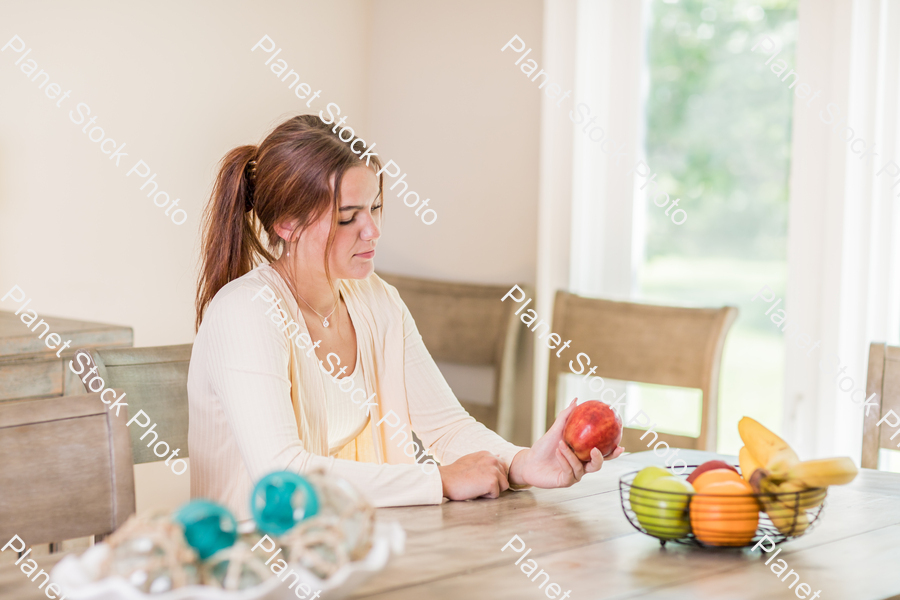 A young lady grabbing fruit stock photo with image ID: be827c2a-2d57-4cb2-a2ba-3b8ebb29d787