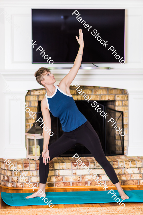 A young lady working out at home stock photo with image ID: bf5c072b-d192-4c8a-8366-07f84d143a72