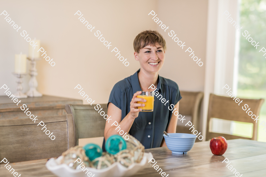 A young lady having a healthy breakfast stock photo with image ID: c1928412-3a06-485c-8577-f10699127fe5