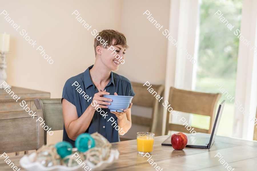 A young lady having a healthy breakfast stock photo with image ID: c28c3911-fe41-440a-8b18-df0f05972bf8