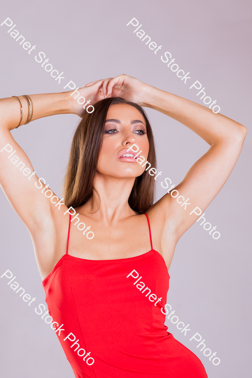 Model in red dress, posing for a studio photoshoot stock photo with image ID: c2f9621d-84f2-401d-8515-24997693acc1