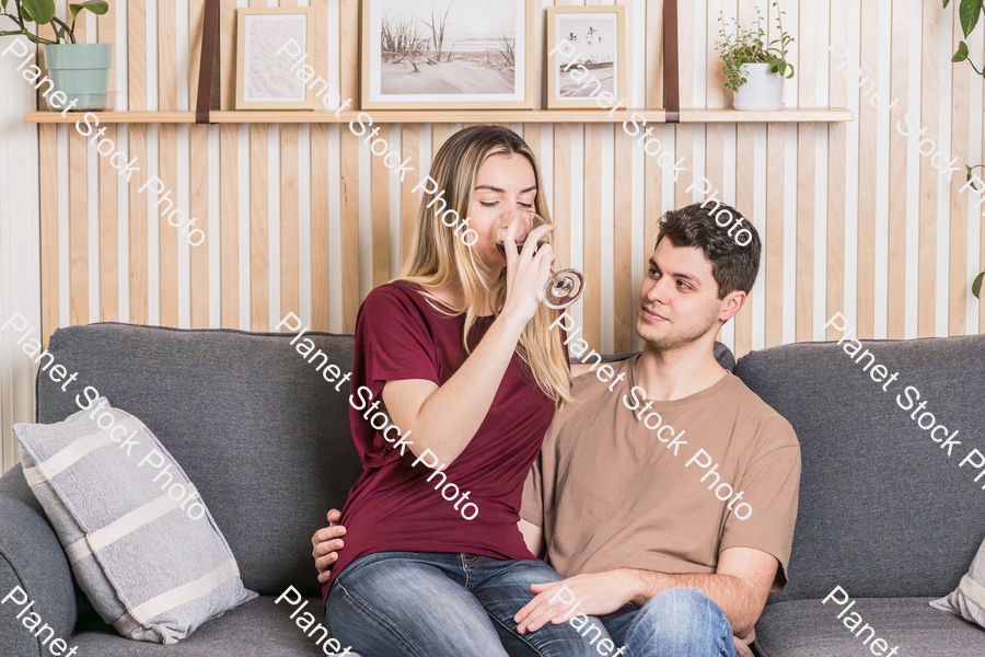 A young couple cozying up on the couch stock photo with image ID: c312433b-9b22-4551-9389-36f7c76dbcc8