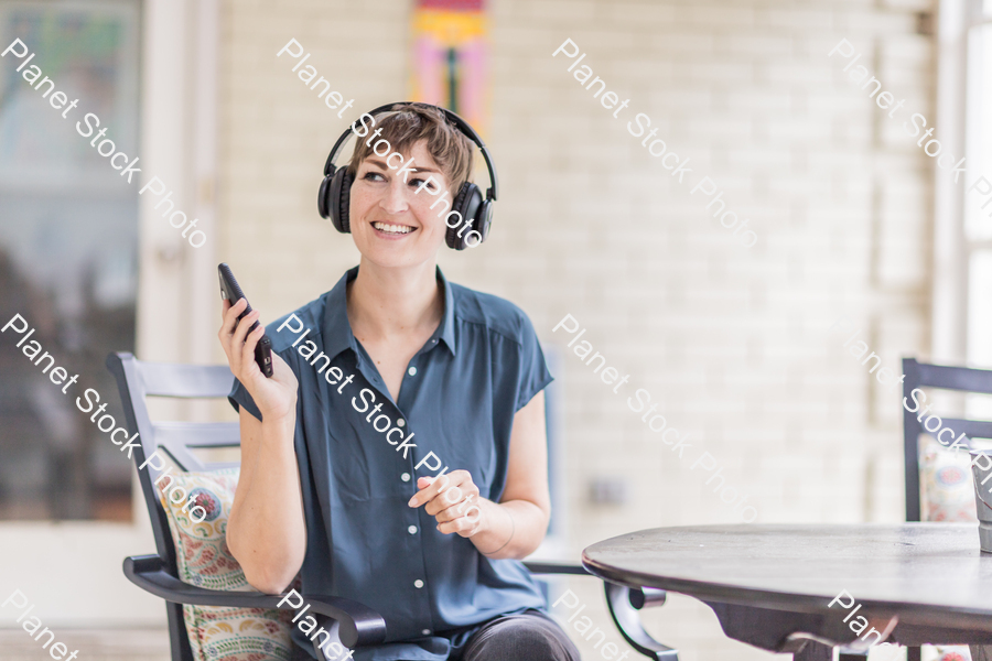 A young lady enjoying daylight at home stock photo with image ID: c350676e-fe22-4594-914d-38dbf367d027