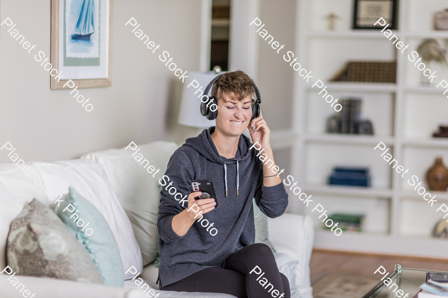 A young lady sitting on the couch stock photo with image ID: c43d5485-7c32-4237-a69e-f3cfc22c432b