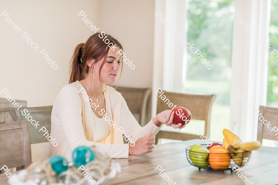A young lady grabbing fruit stock photo with image ID: c488eb3c-5fce-4205-ab5f-b6b46d4debd6