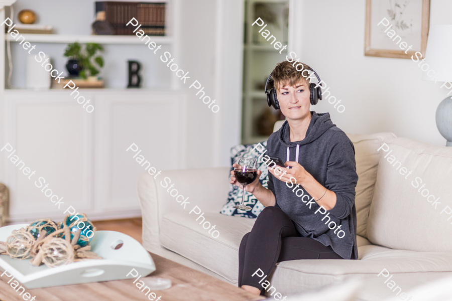 A young lady sitting on the couch stock photo with image ID: c4a1c433-5f66-40cb-82f2-21e4777b34f0