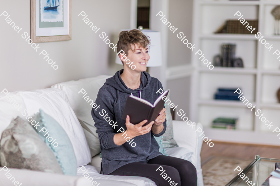 A young lady sitting on the couch stock photo with image ID: c5686705-e9ac-4f67-9965-9b65d3de116f