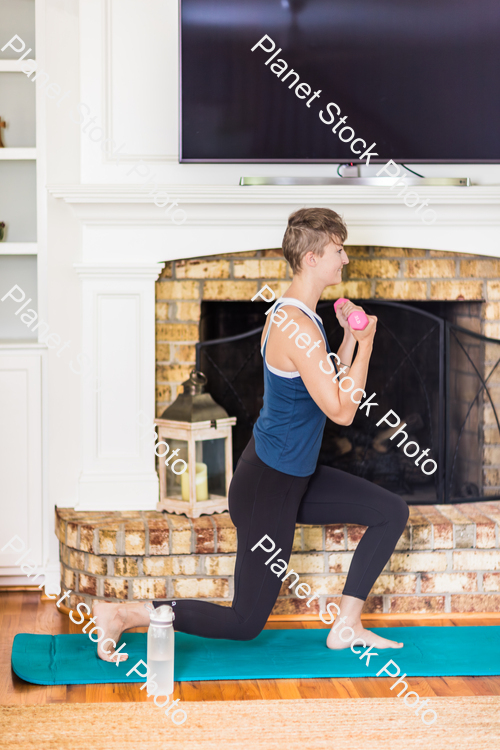 A young lady working out at home stock photo with image ID: c5cf1f5c-38f1-42c5-a361-d9be5ef4d49e