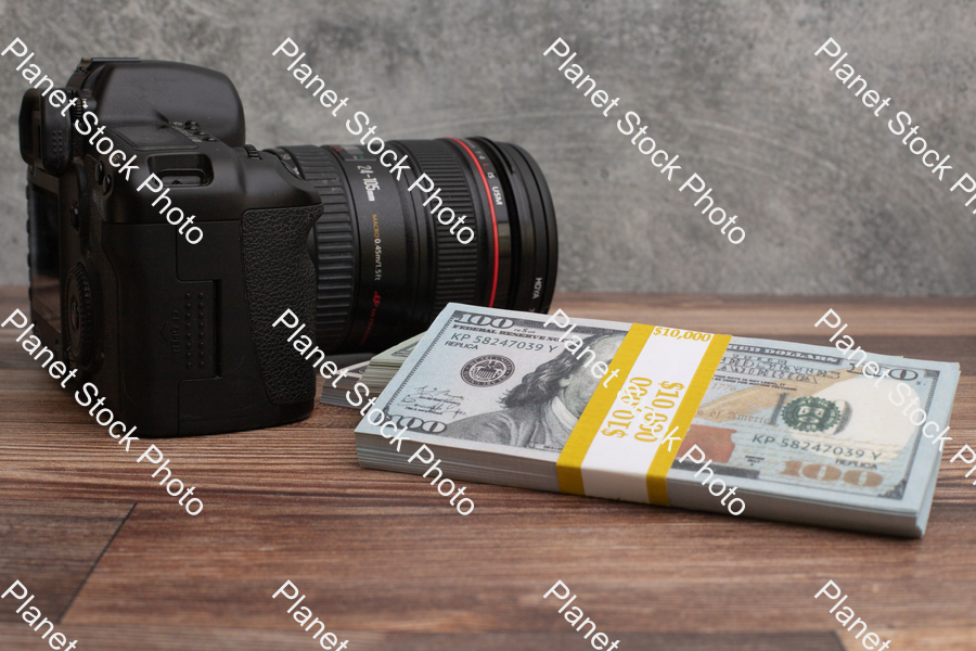 Three stacks of dollar-bills,  with a digital DSLR camera stock photo with image ID: c640196f-296d-484c-92a4-1def37c2a90e