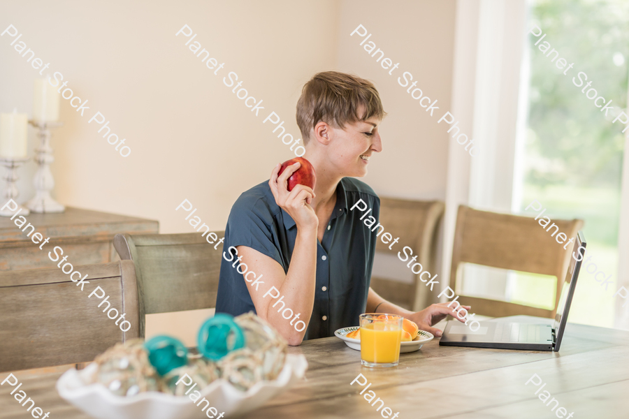 A young lady having a healthy breakfast stock photo with image ID: c7bf2c5a-3010-4d89-a9e7-e37df03e6bbd