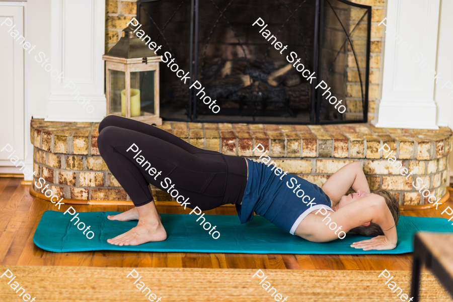 A young lady working out at home stock photo with image ID: cac21e57-ca31-4162-98af-2ef85819acef