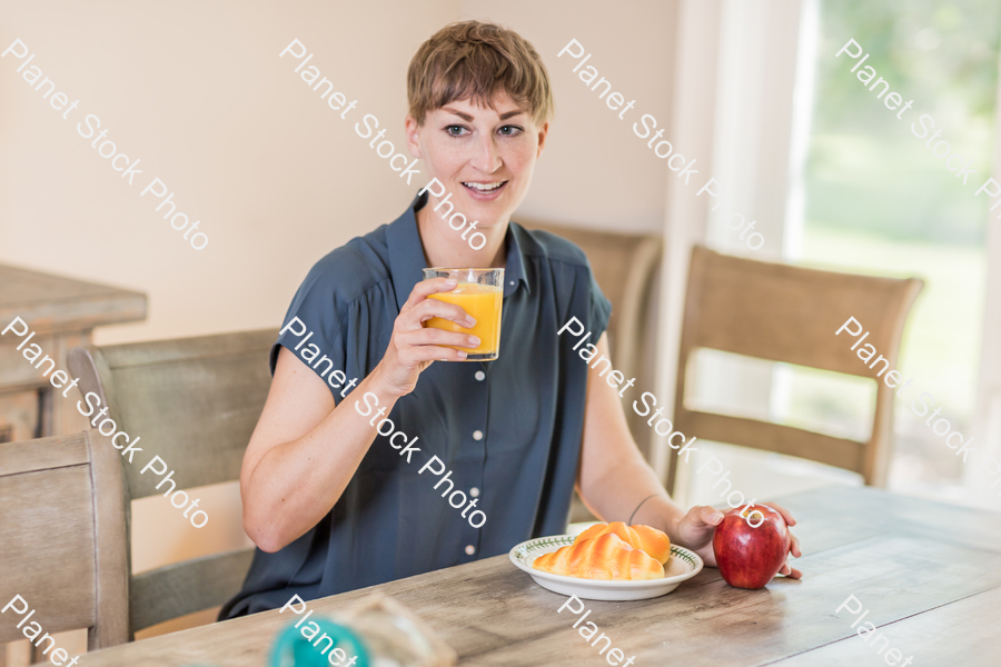 A young lady having a healthy breakfast stock photo with image ID: ce4d274f-f74c-475f-a627-984a98b9c20a