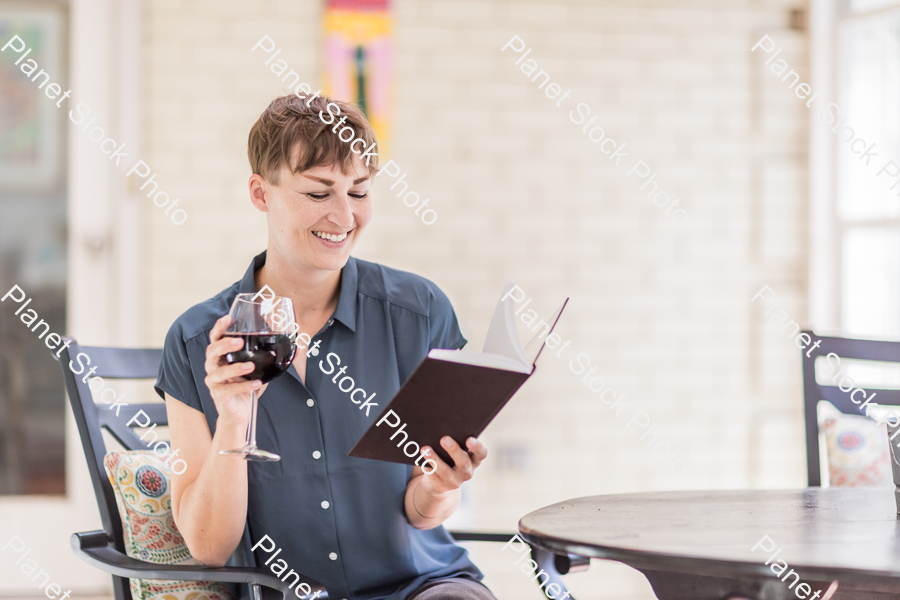 A young lady enjoying daylight at home stock photo with image ID: cef20575-d382-41d4-9f60-565cfa48cd84