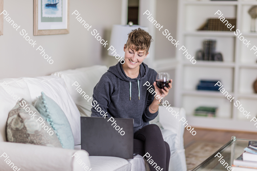 A young lady sitting on the couch stock photo with image ID: d20a3941-968b-4957-b528-cb19c2f03916