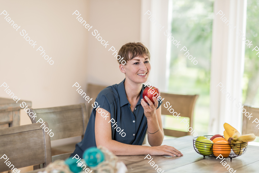 A young lady grabbing fruit stock photo with image ID: d2c070ea-5cf3-44e5-8a3b-53227616f131