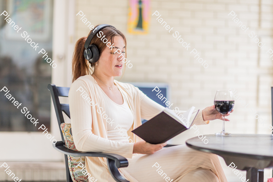 A young lady enjoying daylight at home stock photo with image ID: d6fc1e81-e8d5-4a53-8fd5-4e61d841a0d4