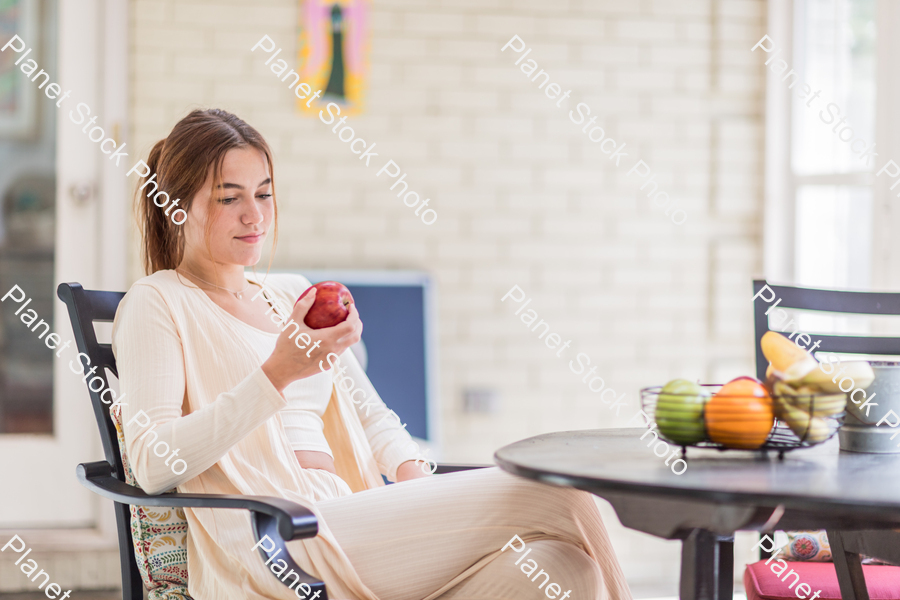 A young lady enjoying daylight at home stock photo with image ID: d71c84f7-d366-4f61-996f-2a48f0d882fa