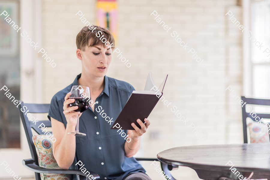 A young lady enjoying daylight at home stock photo with image ID: d9cfe007-88b0-46b1-880f-16335f67ef16