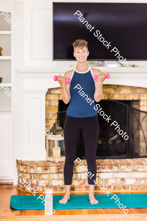 A young lady working out at home stock photo with image ID: db2cf3b1-f4c4-47c9-a3e2-406de3bbc8d3