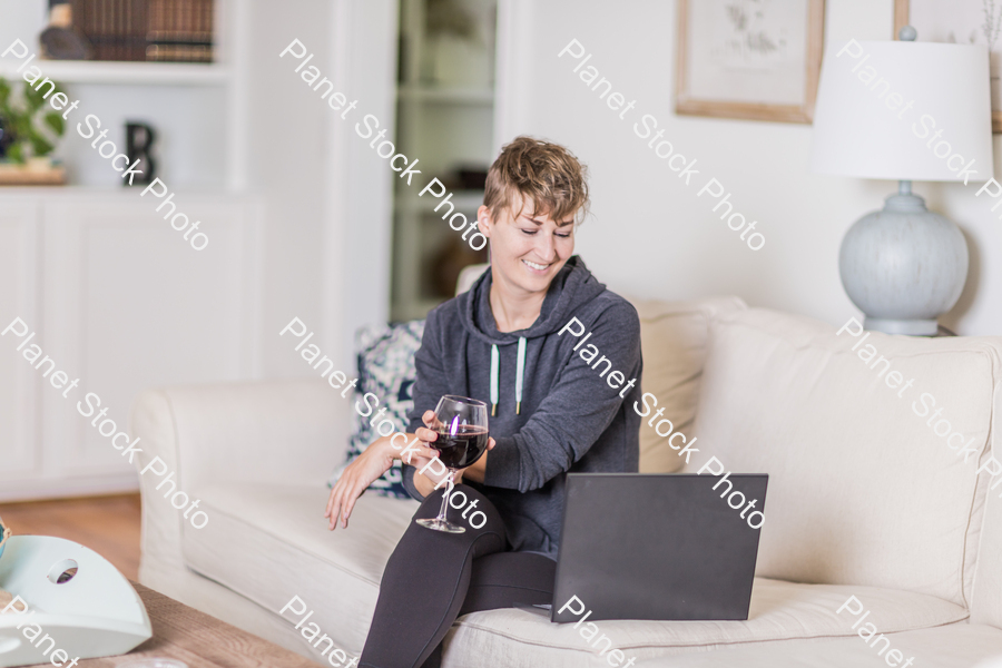 A young lady sitting on the couch stock photo with image ID: db31a3b2-dbef-4cbc-8feb-366a1d1442e0