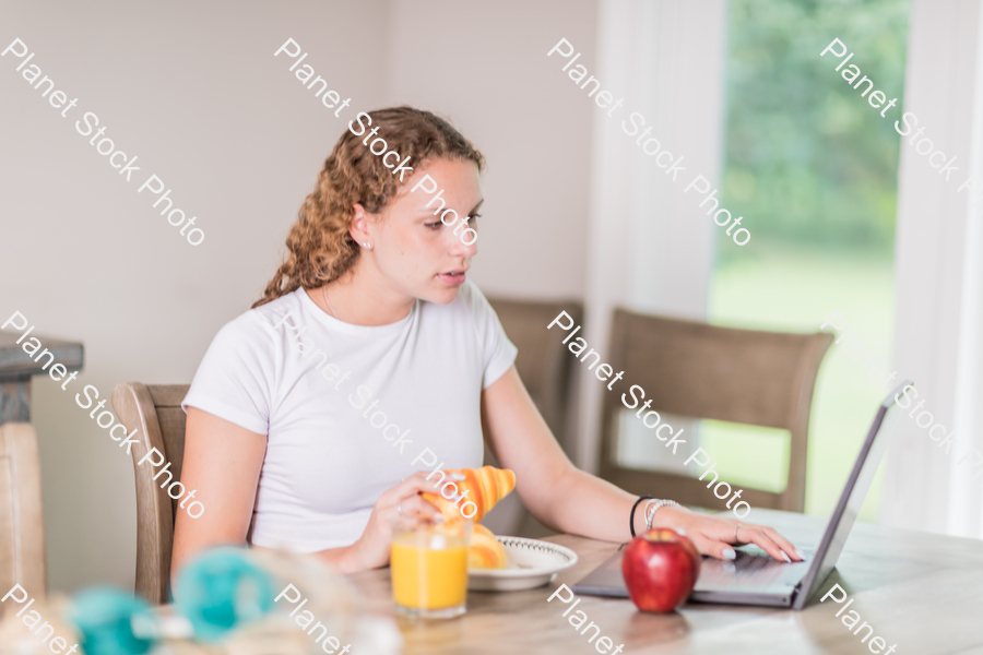 A young lady having a healthy breakfast stock photo with image ID: dd6520bf-82aa-49c5-86c4-6b58d03fb990